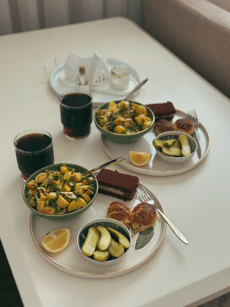 Inviting table setup with fresh salad, lemon tea, and dessert for a delightful meal.